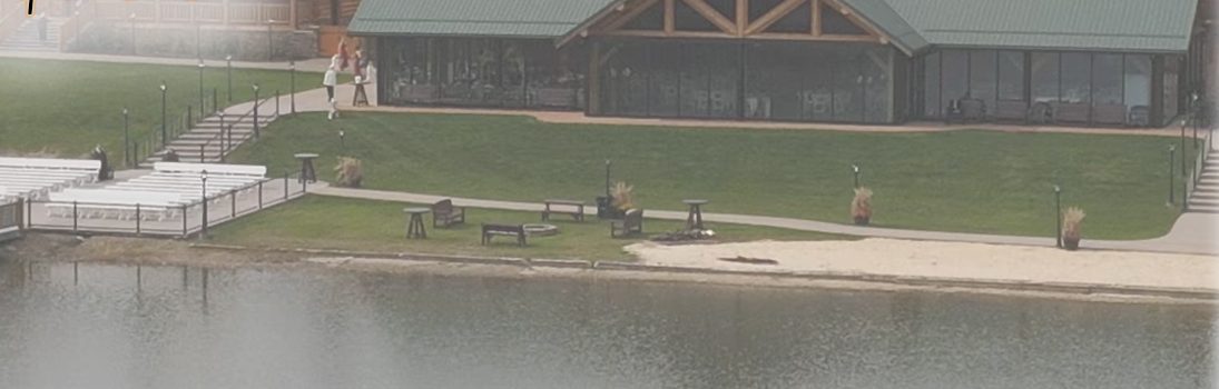 Lakeside venue with a lodge-style pavilion and lawn