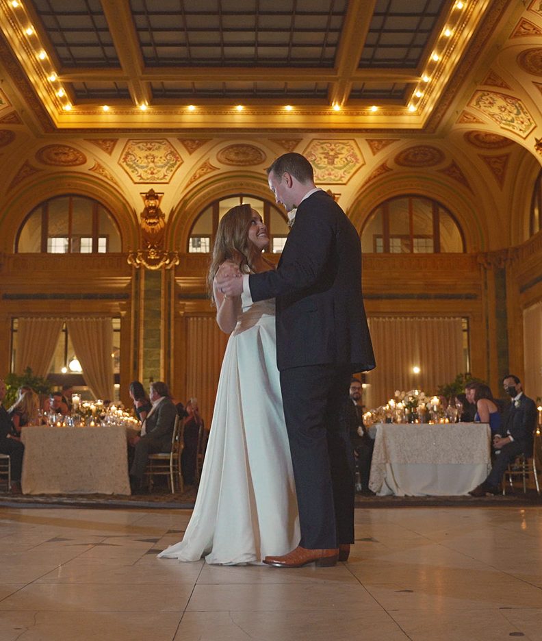 Couple's first dance in an ornate gilded ballroom