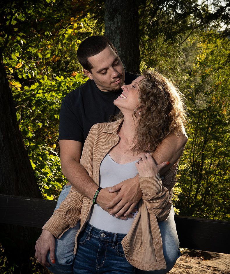 Couple embracing among autumn trees, a relaxed outdoor portrait session